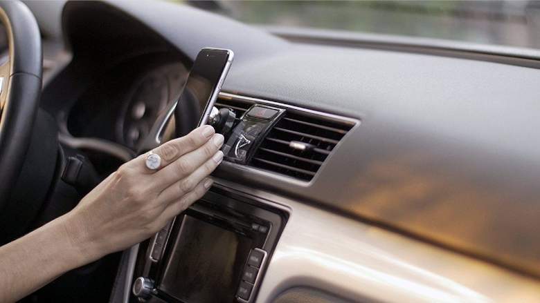 woman pulling her phone out of her dashboard mounted phone holder