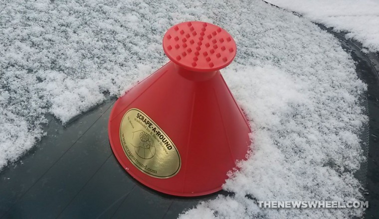 The Scraper Cone sitting on a snowy windshield