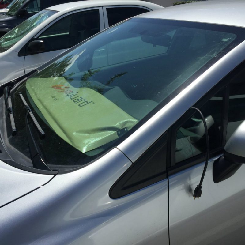 WarmGuard windshield heater sitting on a cars dashboard